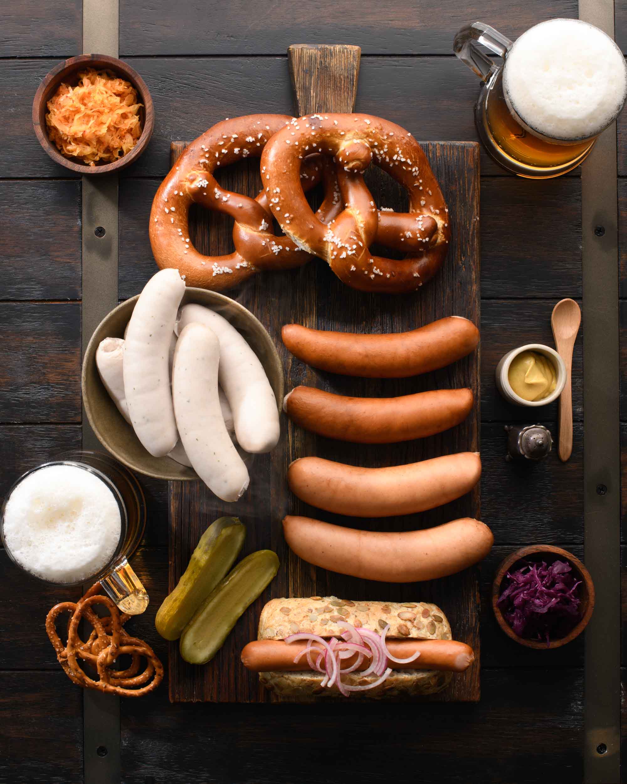Gotzinger Smallgoods German Sausages on platter with pretzel and beer
