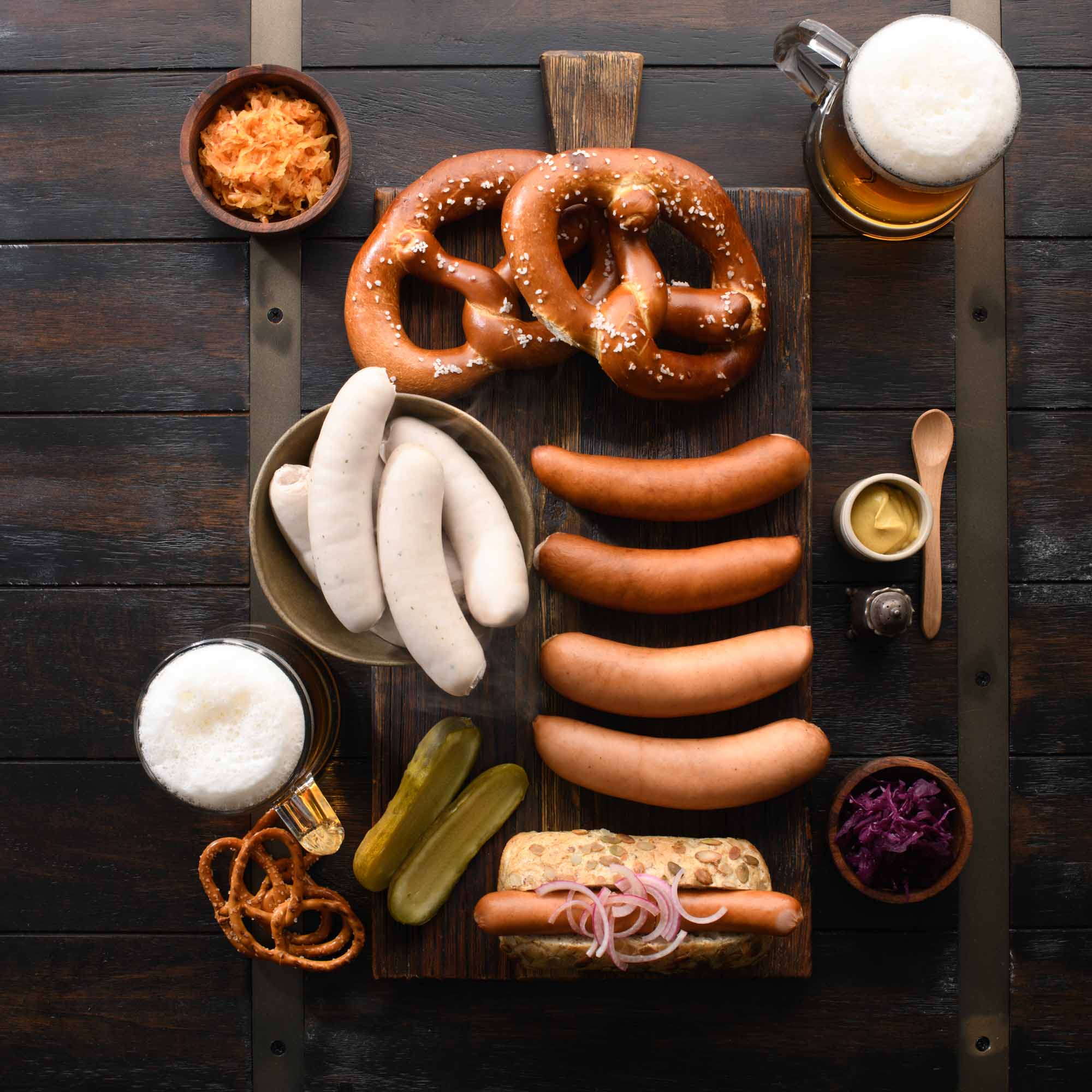 Gotzinger German Sausages on wooden platter with sauerkraut and beer
