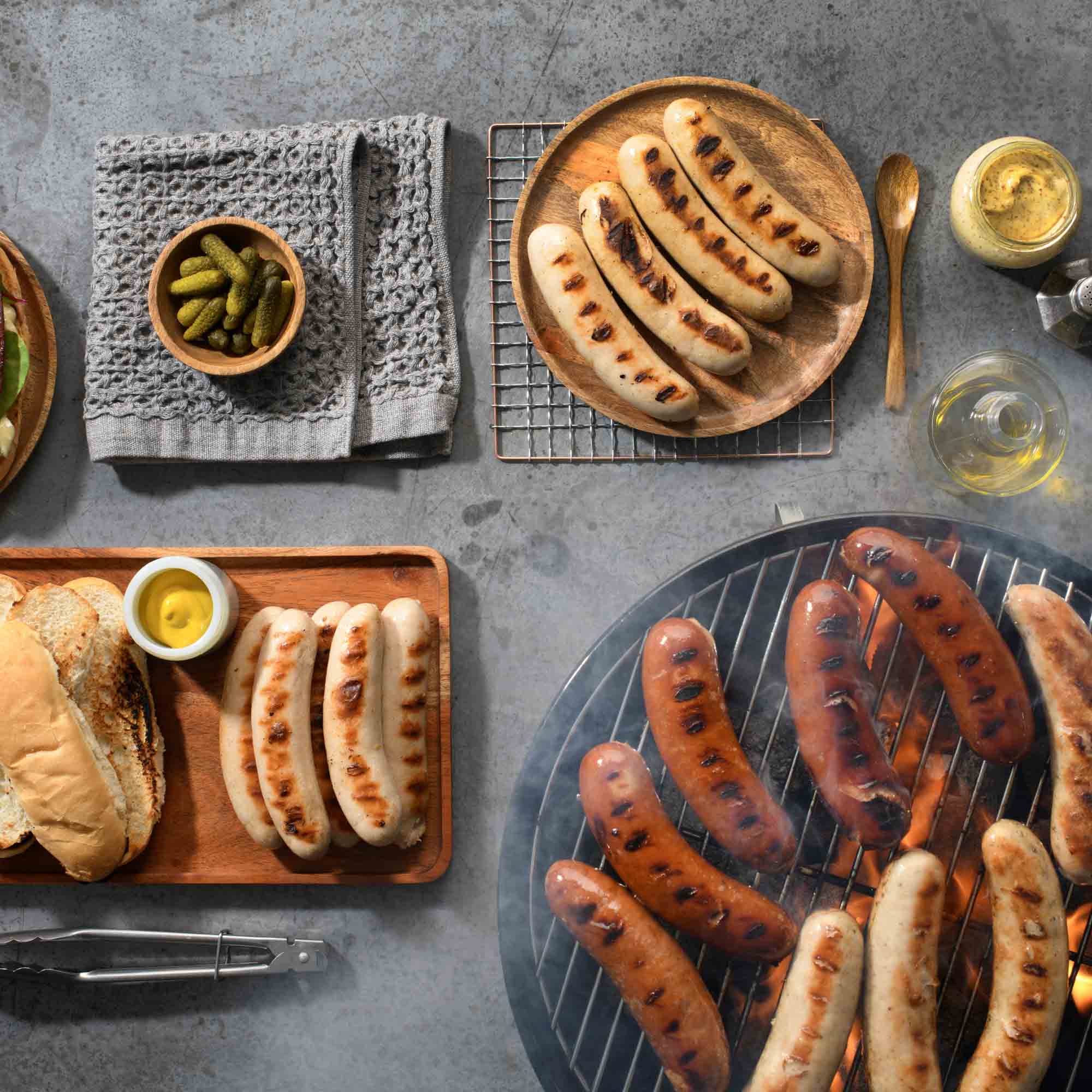 Gotzinger Smallgoods Grilling Brats on Barbecue with Condiments