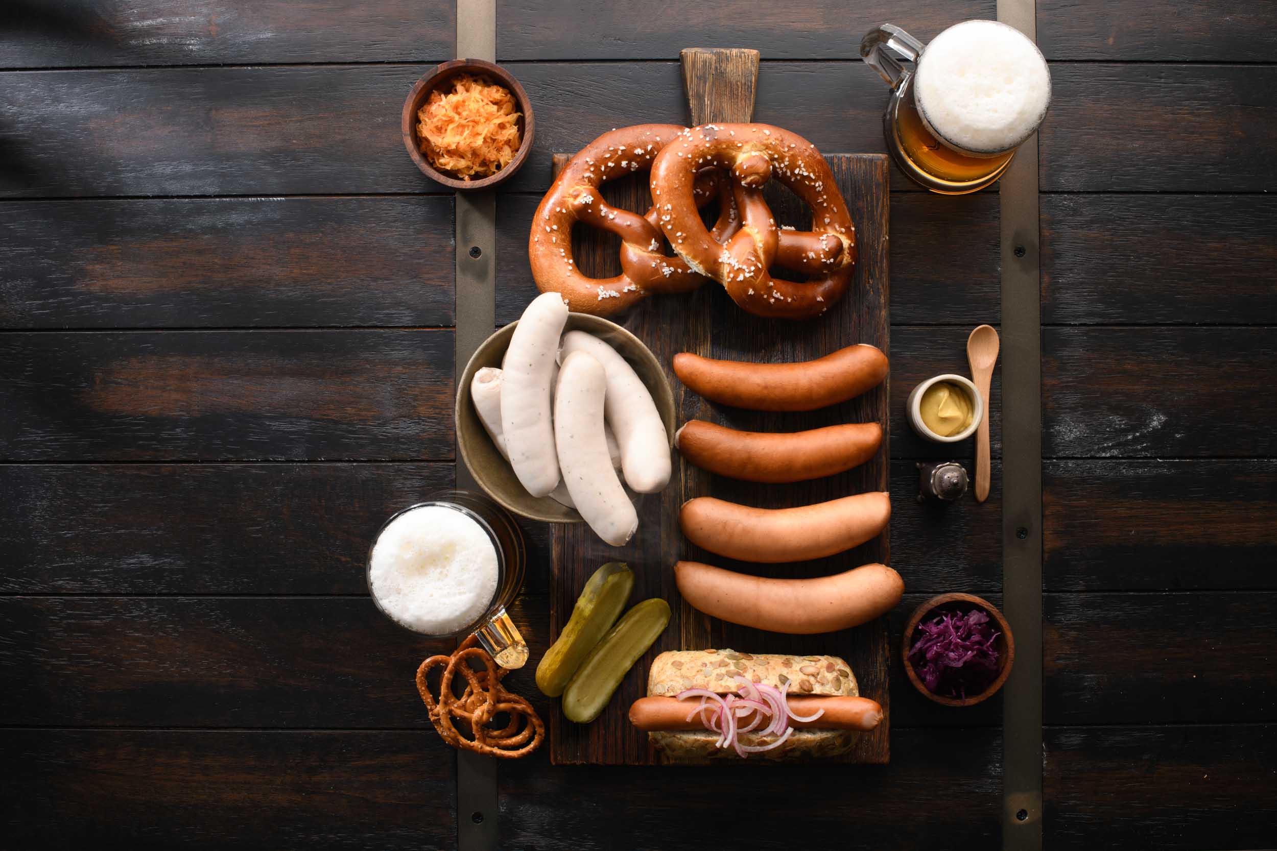 Gotzinger Smallgoods German Sausages on platter with pretzel and beer